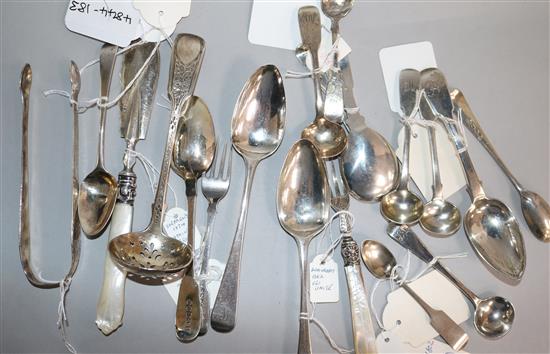 Nineteen assorted small items of flatware including, caddy spoon, sugar tongs, butter knife and sifter spoon.